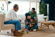 © BONNINSTUDIO/Stocksy - Happy family playing at home