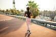 © Igor Kardasov/Stocksy - Faceless black woman in sportswear jogging on walkway