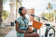 © Igor Kardasov/Stocksy - Young black woman sitting on construction with coffee