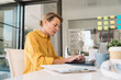 © Santi Nuñez/Stocksy - Businesswoman using laptop in office