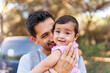© Raul Navarro/Stocksy - portrait of a baby girl laughing with her father
