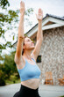 © DZ FILM/Stocksy - A woman does yoga in the backyard