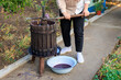 © Iurii Gagarin - A woman works with a press to produce homemade farm wine. Background with selective focus