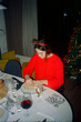 © Marek Minor/Stocksy - Woman enjoying her entree at Christmas dinner table