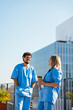 © BONNINSTUDIO/Stocksy - Medical team during conversation on hospital terrace