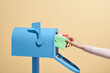 © Marc Tran/Stocksy - Person put or take out the letter by his hand in or out Mailbox.