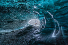 Man Exploring An Amazing Glacial Cave In Iceland