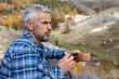 © Melika Tursic/Stocksy - man drinking coffee in mountains