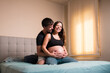 © Ibai Acevedo/Stocksy - Happy couple sharing pregnancy process
