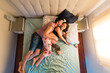 © Ibai Acevedo/Stocksy - Loving pregnant couple kissing on bed
