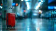 a red luggage travel case in the middle of airport hall. people crowd walking motion in the blurry background. wallpaper background