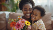 A black mother woman lovingly holds a little girl who proudly presents a bouquet of colorful flowers in their hands, Mother`s Day Concept