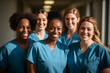 © Pramesti - Diverse team of nurses in blue scrubs smiling at the camera