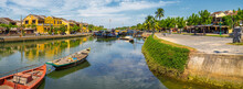 Boats on a river through an historic Asian town at Hoi An in Vietnam