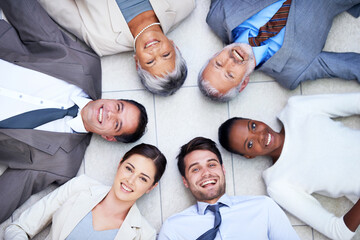 Canvas Print - Floor, circle and portrait of team with smile for support, collaboration and solidarity. Professional employees, happy and diversity in office with trust, unity and partnership together from above