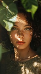 Wall Mural - Portrait of a beautiful young woman with green eyes and curly hair