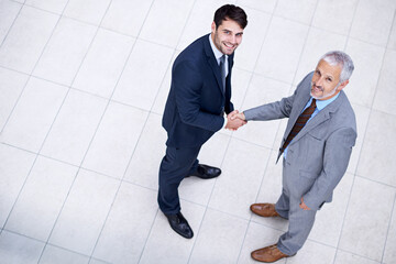 Wall Mural - Portrait, handshake and smile of business people with CEO for deal, collaboration or b2b partnership agreement for consultant. Top view, shaking hands or men in office for acquisition on mockup space