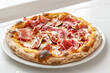 Gourmet Fig and Prosciutto Pizza on White Table Gen AI