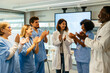 © BONNINSTUDIO/Stocksy - Healthcare workers having a meeting at hospital