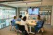 © BONNINSTUDIO/Stocksy - Doctors having a presentation to medical colleagues