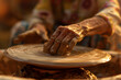 a person's hands sculpting and shaping clay or pottery on a potter's wheel to create functional or decorative ceramic pieces