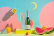 summer, modern and minimalistic still life featuring a champagne bottle, watermelon,coctails, and geometric shapes on a pastel colored background in pink, yellow, blue, and green colors