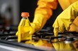 Woman cleaning electric stove with spray bottle and cloth, close-up shot in kitchen