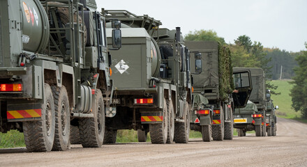 Wall Mural - a convoy of British army utility vehicles in action on a military exercise, Wilts UK