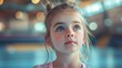 Close up portrait of Young little girl practicing gymnastic, working out in training class, wearing sportswear, indoor, gym interior background, preparing performance. Active sporty life concept