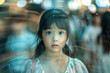 A young Asian girl standing in a moving crowd with a worried facial expression, anxiety concept