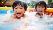 © tota - プールで水遊びをする子供、元気な夏の日本人の男の子