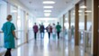 © VistaVisions - Blur image background of hospital clinic corridor doctors nurses walking in hallway glass window ceiling door healthcare