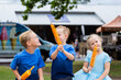 © Austockphoto - Siblings sitting together with potato spiral chips to eat at local event