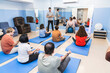 © Koldo_Studio - A diverse group engages in a yoga class, including two with Down syndrome.