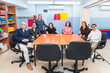 © Koldo_Studio - Teacher with mental disabled students, some with Down syndrome, in a vibrant classroom.