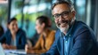 © twentyone - Portrait of a man sitting at a meeting table. senior professor at the meeting.