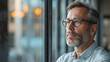 © safu designe - Pensive mature male CEO looking through window, thinking about startup, planning new projects, waiting for meeting in modern office