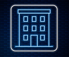 Poster - Glowing neon line Multi storey building icon isolated on brick wall background. Vector