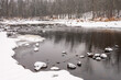 Rocks in river covered  in the snow