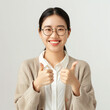 © LightCapturer - Happy smiling young Asian female teacher in a cardigan and white shirt