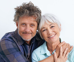 Poster - Old couple, face and hug with happiness in studio, love and security with comfort for bonding. Marriage partner, retirement and smile in portrait, people with trust and loyalty on white background