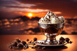 closeup of stracciatella and chocolate flavored ice cream in an elegant chromed metal cup in front of a fiery sunset