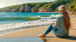 Female traveler dressed in pants and shirt sitting on the seashore in summer relaxing on the beach looking at the horizon with copy space. Summer vacation and relaxation concept