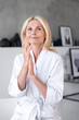 © brizmaker - Woman with healthy hands and nude nails applying cosmetic product
