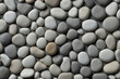 Background of stones. Grey pebble stones pattern, top view, pebbles wallpaper, grey background. Natural pebble stones background.