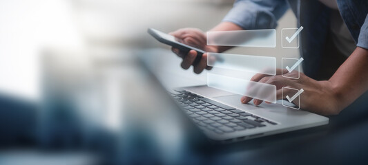 Digital smart checklist and business management concept. Businessman uses laptop to mark paperless office and document management and future business on checklist