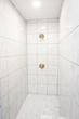 White and gray marbled tile large empty recently renovated home shower in a master bathroom