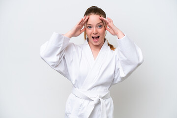 Wall Mural - Young caucasian girl doing karate isolated on white background with surprise expression