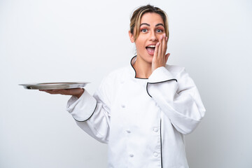 Canvas Print - Young chef woman with tray isolated on white background with surprise and shocked facial expression