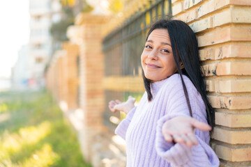 Wall Mural - Young woman at outdoors smiling